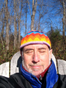 David outdoors eyes closed, wearing colorful hat, 12/12/2009